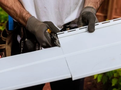 Cutting vinyl siding on a job site in Calgary