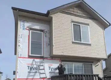 Calgary home with frequent siding repairs indicating it is time for a full siding replacement