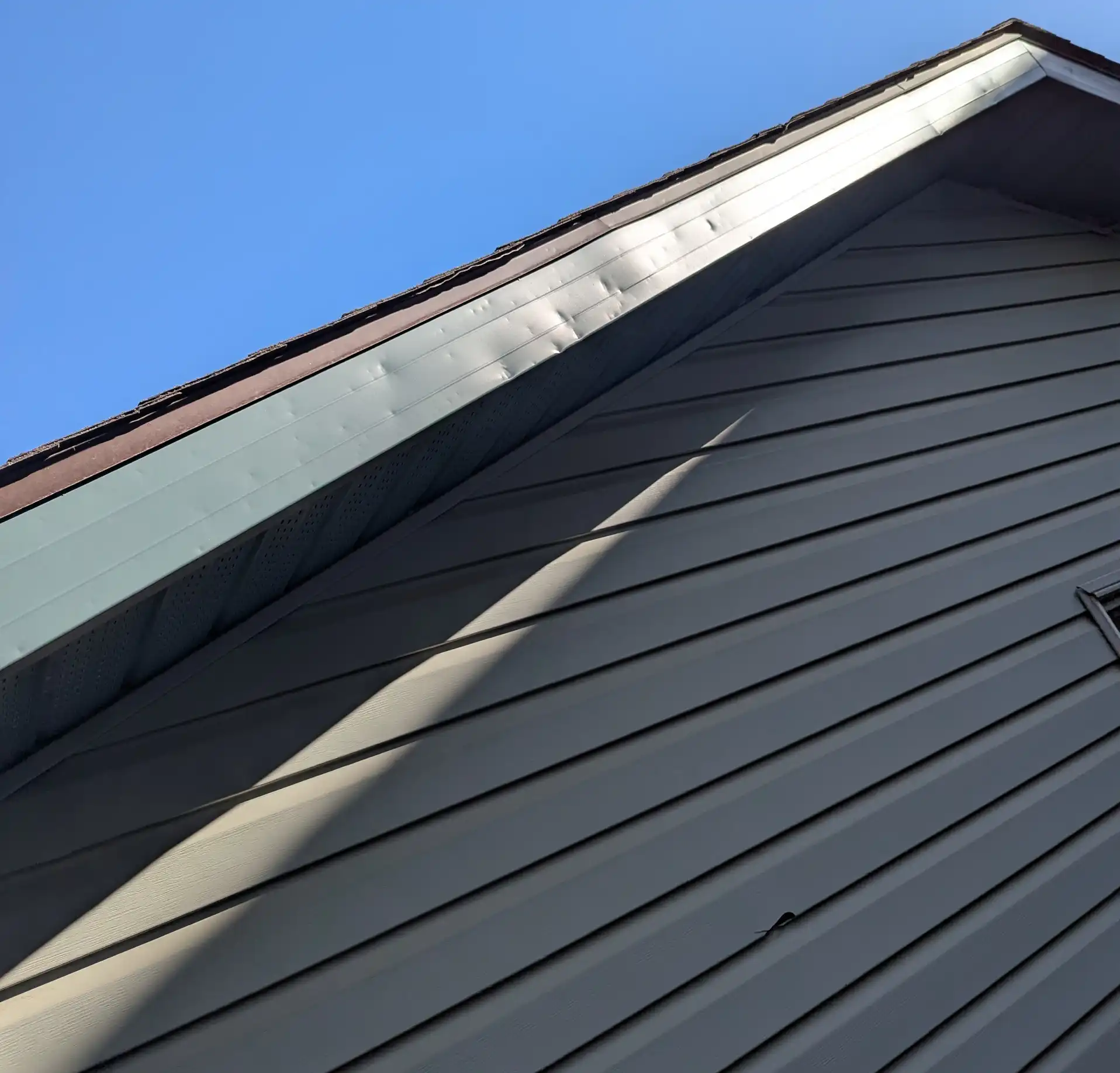 Siding corners, J-channels and trim installation on a Calgary home by Blueprint Construction