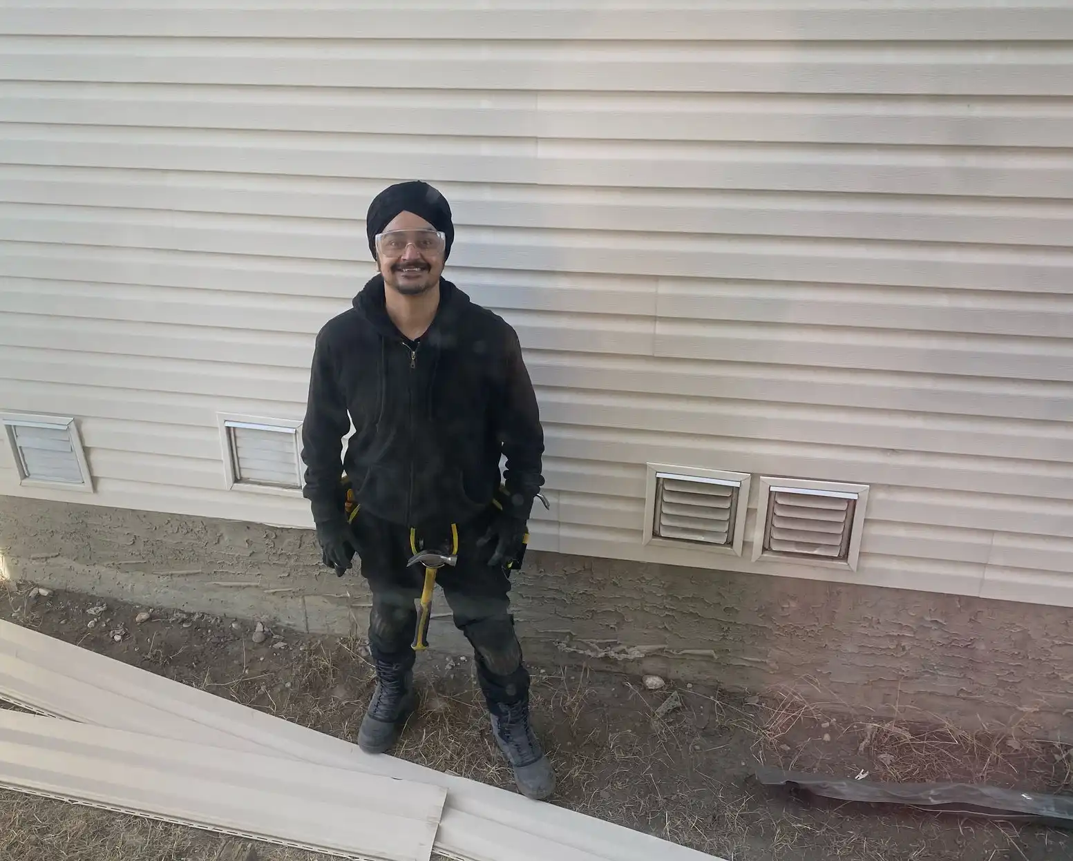 Blueprint Construction contractor completing a final walkthrough of a finished siding installation on a Calgary home