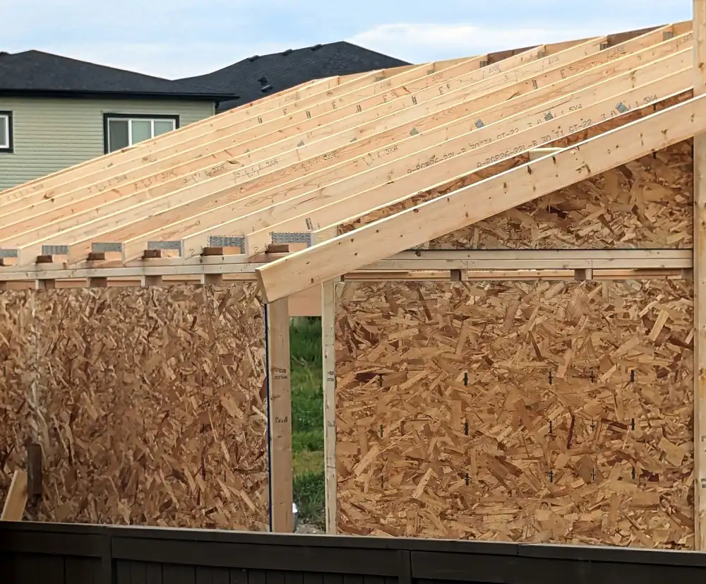 Roof trusses and OSB sheathed walls on a new detached garage under construction in Calgary